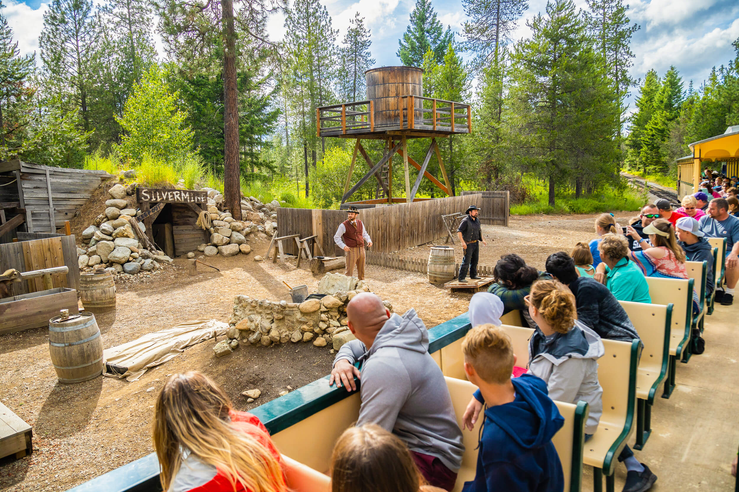 Idaho amusement park visitors ride a train and watch the Silver Mine Shootout performance at Silverwood Theme Park.