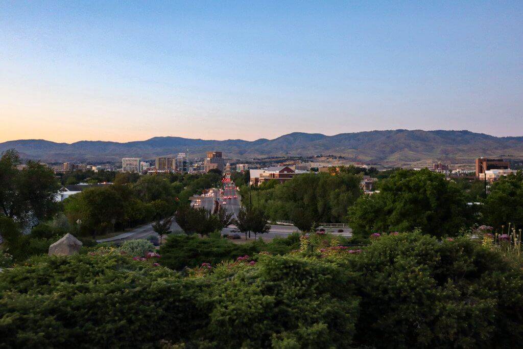 wide view of Boise, with buildings along skyline and foothills in the background