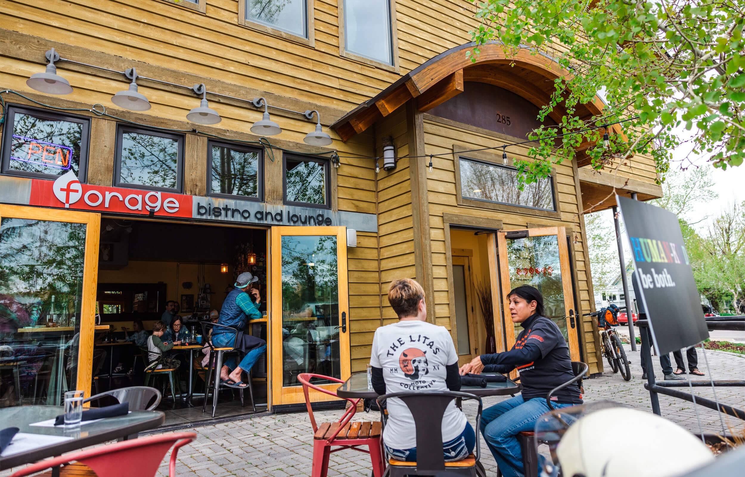 Two people sit outside of Forage Bistro and Lounge in Driggs, Idaho.