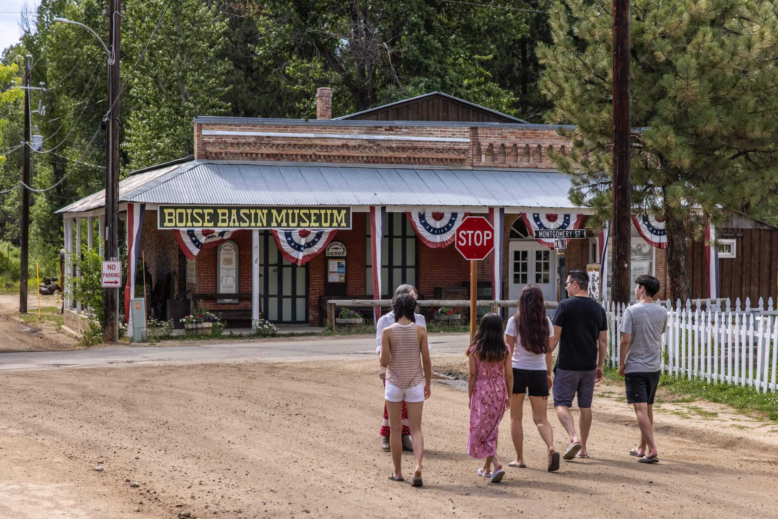 a group of people walking toward the Boise Basin Museum