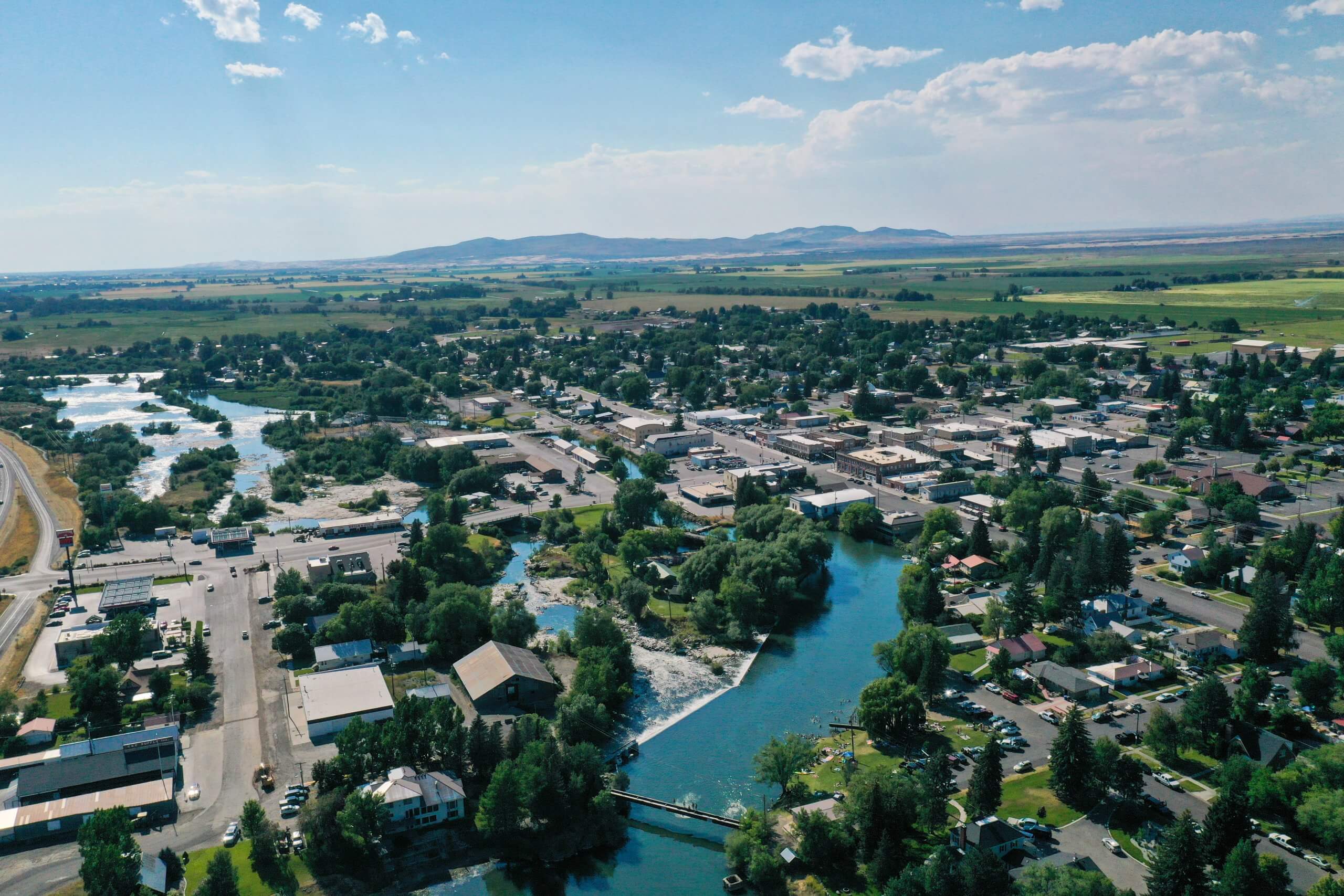 birds-eye view of a river winding through the town of saint anthony