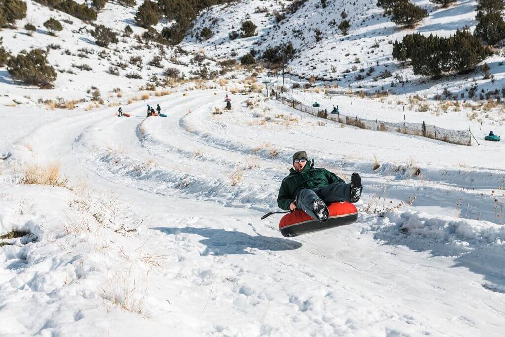 A man catches air while on a snow tube at the McCall Activity Barn.