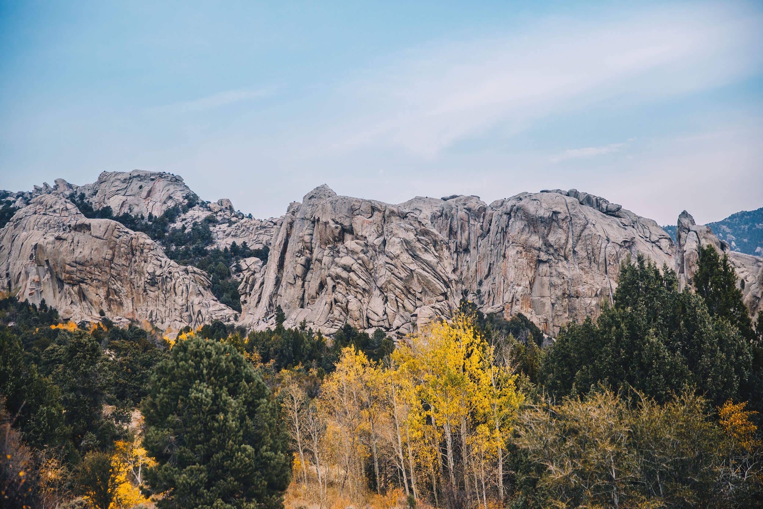 Rock formations with yellow and green trees in the foreground